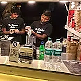 Two of the team blending drinks behind the counter